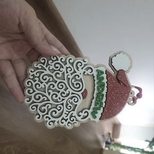 Santa Claus hangs Christmas tree decorations